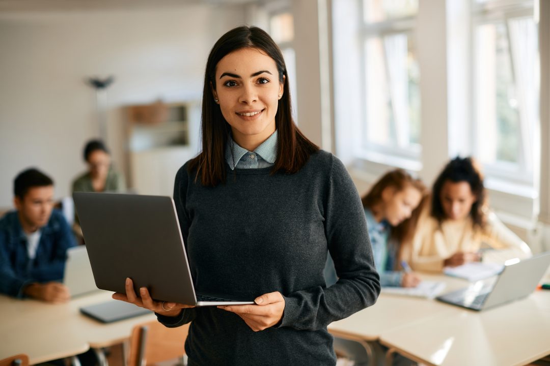 photo of teacher holding laptop